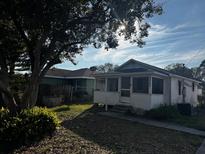 Charming single-story home with a screened front porch and beautiful landscaping at 3265 Conine, Winter Haven, FL 33881