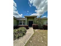 Charming front entrance featuring a double door and well-manicured landscaping at 3851 Horizon View Loop, Lakeland, FL 33813
