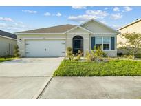 Charming single-story home featuring a well-maintained lawn and a two-car garage with driveway at 4333 Pumice Dr, Lakeland, FL 33811