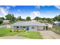 Charming single-story home with a well-manicured lawn and metal roof, exuding curb appeal at 498 W 7Th St, Frostproof, FL 33843