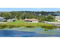 Waterfront home on large lot with lush landscaping and mature trees providing privacy at 553 Thornburg Rd, Babson Park, FL 33827