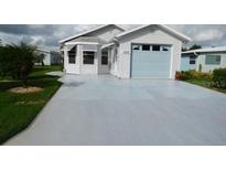 Charming single-story home features a one-car garage and well-manicured front lawn at 6398 Lolly Bay Ne Loop, Winter Haven, FL 33881