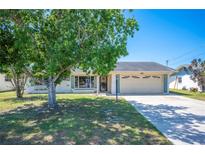 Charming single-story home with a well-manicured lawn and an attached two-car garage at 109 Pasco Se Rd, Winter Haven, FL 33884