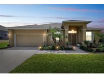 Charming single-story home featuring a well-manicured lawn, a two-car garage, and inviting front entryway at 132 Dinner Lake Ave, Lake Wales, FL 33859