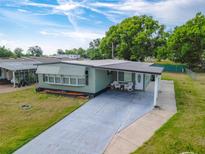 Charming home featuring a covered entryway, a long driveway, and a well-maintained lawn at 1610 Reynolds Rd # 242, Lakeland, FL 33801