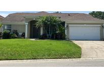 Charming single-story home with a well-manicured lawn and mature trees at 1681 Waterview Loop, Haines City, FL 33844