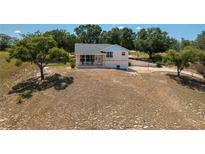 Charming single-Gathering home on a large lot with mature trees and a spacious front yard at 2390 Lake Easy Rd, Babson Park, FL 33827