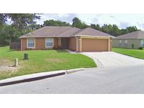 Charming single-story home featuring a well-maintained lawn, a driveway, and an attached two-car garage at 3430 Hilson Dr, Lakeland, FL 33812