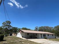 Charming one-story home featuring a large carport and attached storage shed at 3949 Millstone St, Lake Wales, FL 33898