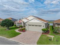 Beautiful single-story home with a two-car garage, brick driveway, and well-manicured landscaping at 4081 Dunmore Dr, Lake Wales, FL 33859