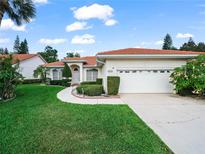 Charming single-story home boasts a well-manicured lawn, lush landscaping, and a welcoming two-car garage at 530 Greenway Dr, Lake Wales, FL 33898