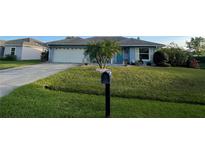 Charming single-story home features a well-maintained front yard, a garage, and a mailbox at 716 Maderia Ct, Kissimmee, FL 34758