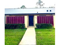 Charming single-story home featuring a well-manicured lawn and a secure gated entrance at 1012 Medinah Dr, Winter Haven, FL 33884