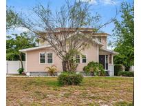Charming two-story home featuring mature trees, a well-maintained lawn and a welcoming entrance at 102 Deen Blvd, Auburndale, FL 33823