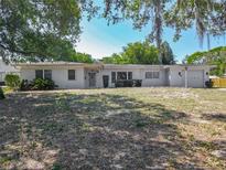 Charming single-story home featuring a clean white exterior, mature trees, and a well-maintained front lawn at 1024 Campbell Ave, Lake Wales, FL 33853