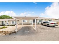 Charming single-story home featuring a covered carport and well-maintained landscaping at 151 Winter Ridge Dr # 151, Winter Haven, FL 33881