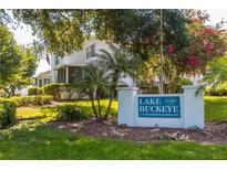 Lake Buckeye condominium community sign is surrounded by mature trees and landscaping at 1550 11Th Ne St # E7, Winter Haven, FL 33881
