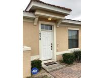 Inviting front entrance features a well-maintained door, updated paint, and a tidy landscape at 1820 Coriander Dr, Poinciana, FL 34759