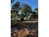 Charming homes nestled among mature trees offer curb appeal on a bright, sunny day at 229 Ne Avenue B, Winter Haven, FL 33881