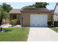 Charming single-story home with a well-manicured lawn, mature plants and a one car garage at 266 Las Flores, Winter Haven, FL 33884