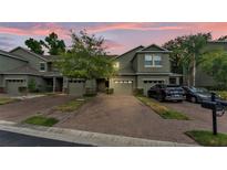 Charming two-story townhome with brick driveway, attached garages, and well-maintained landscaping at 6343 Torrington Cir, Lakeland, FL 33811