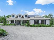 Charming one-story home featuring a manicured front yard, white trim, and inviting front porch at 1850 S Lake Reedy Blvd, Frostproof, FL 33843