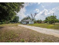 Quaint single-story home featuring a large yard and a classic, welcoming facade under a bright sky at 1949 Old Bartow Rd, Lake Wales, FL 33859
