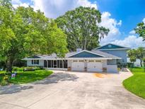 Charming single-Gathering home with lush landscaping, a spacious driveway, and a three-car garage at 250 Brigham Nw Rd, Winter Haven, FL 33881