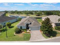 Beautiful single-story home with a well-manicured lawn and a serene pond view in a lovely community at 3844 Bedford Ave, Winter Haven, FL 33884
