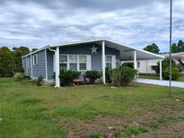Charming single-story home with a covered carport, well-maintained lawn, and inviting curb appeal at 418 Tivoli Park Dr, Davenport, FL 33897