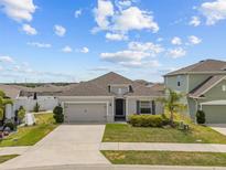 Charming single-story home with a well-manicured lawn, tidy landscaping, and a two-car garage at 622 Taft Dr, Davenport, FL 33837