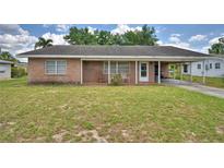 Charming brick home featuring a covered front porch and carport for convenient parking at 780 Oleander Se Dr, Winter Haven, FL 33880