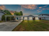 Charming single story home boasts mature landscaping, carport, and is freshly painted at 900 Lake Jessie Dr, Winter Haven, FL 33881