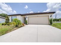 Charming one-story home featuring an attached two car garage and freshly landscaped yard at 1050 Michelangelo Ln, Winter Haven, FL 33884
