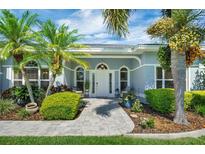 Charming home featuring a manicured front yard, lush landscaping, and inviting entrance at 109 Lake Mariam Way, Winter Haven, FL 33884