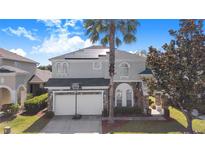 Beautiful two-story home with a two-car garage, solar panels, and a well-manicured lawn at 110 Minniehaha Cir, Haines City, FL 33844