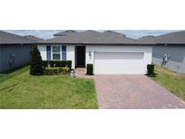 Charming single-story home with a brick driveway and well-maintained landscaping at 1363 Benevento Dr, Winter Haven, FL 33884