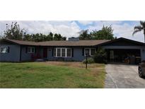 Charming single-story home featuring a cozy front porch, open garage, and neatly landscaped yard at 1987 8Th Se St, Winter Haven, FL 33880