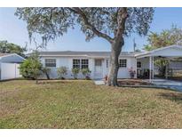 Charming single-story home with a well-maintained lawn and covered parking at 2409 E Civitan Ave, Lakeland, FL 33801