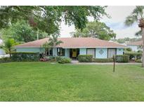 Beautiful one-story home boasts lush green grass and landscaping at 255 Lake Link Rd, Winter Haven, FL 33884