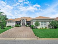 Charming single-story home with a brick driveway, well-manicured lawn, and a welcoming entrance at 4004 Sable Loop Dr, Lake Wales, FL 33859