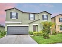 Charming two-story home with a well-maintained lawn and a two-car garage at 4400 Trotters Way, Lakeland, FL 33801