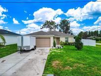 Charming single-story home with a well-maintained lawn, driveway, and appealing curb appeal at 47 Willow Ln, Kissimmee, FL 34759