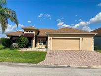 Beautiful home featuring a two-car garage, a fountain, meticulous landscaping, and excellent curb appeal at 5005 Pebble Beach Blvd, Winter Haven, FL 33884
