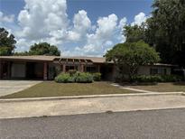 Charming single-story home featuring a well-manicured lawn and inviting curb appeal at 9 Heights Ave, Frostproof, FL 33843