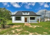 Charming renovated house with a new roof, landscaping, and a classic, inviting facade at 1042 Golden Bough Rd, Lake Wales, FL 33898