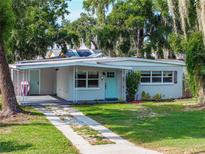 Charming single-story home featuring a well-maintained lawn, inviting walkway, and a pleasing blue accent door at 1140 W Seminole Trl, Bartow, FL 33830