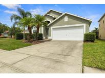 Charming single-Gathering home with well-maintained lawn and landscaping with lovely palm trees at 151 Hideaway Beach Ln, Kissimmee, FL 34746
