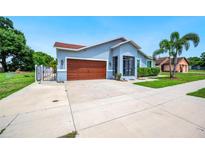Charming single-story home with a two-car garage and a well-manicured lawn at 1553 Wright Dr, Lakeland, FL 33805
