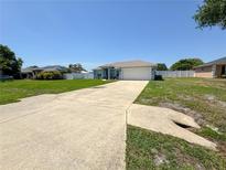 Charming one-story home with a well-maintained lawn, long driveway, and a two-car garage in a suburban setting at 2018 Misty Morning Dr, Winter Haven, FL 33880